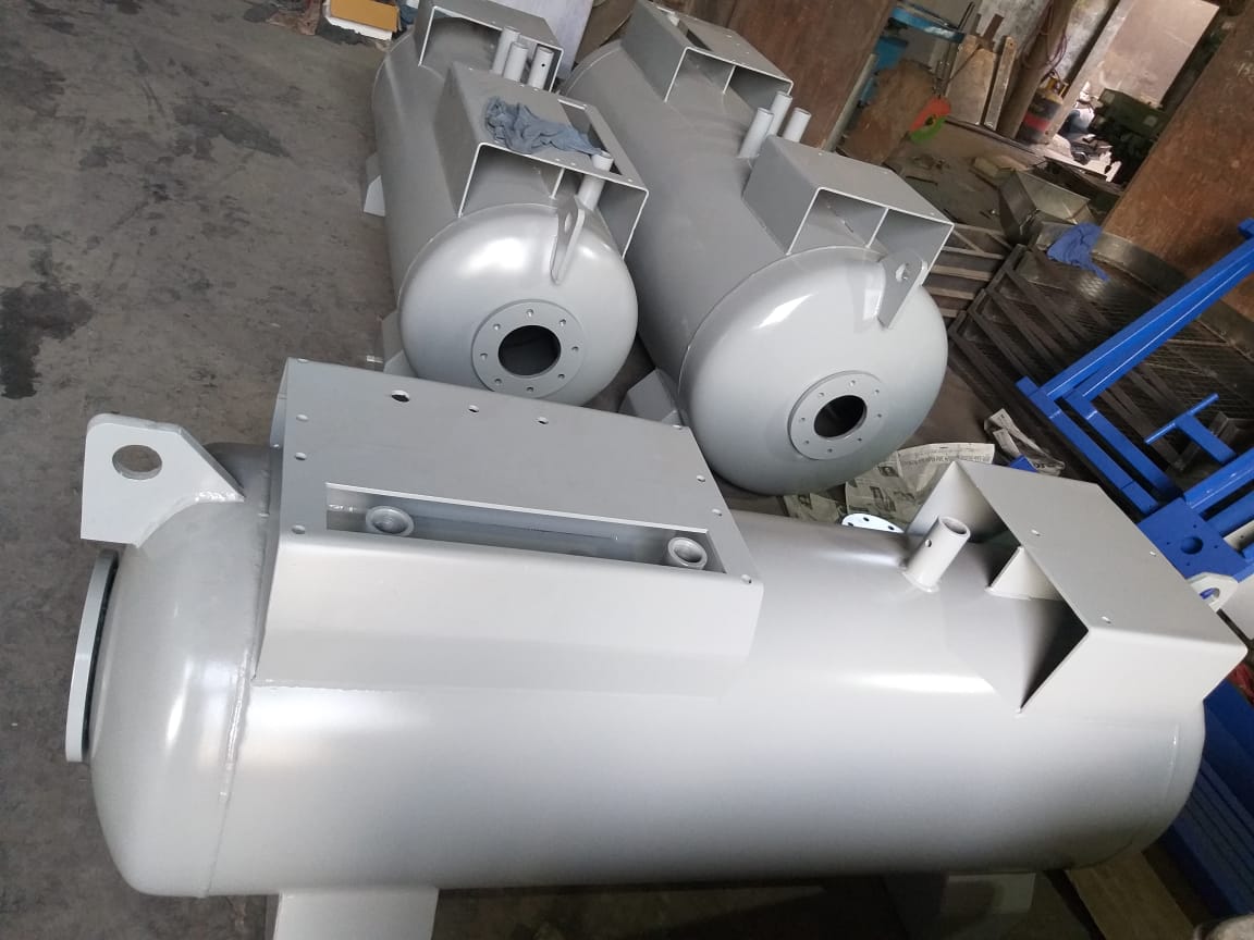 A group of gray compressor tanks with mounting platforms in the Aircon workshop